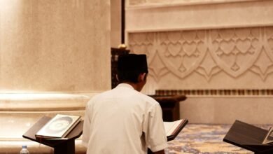 a man sitting on the floor reading a book