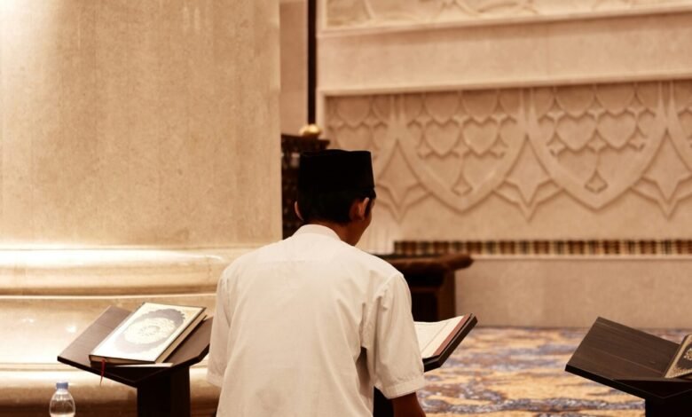 a man sitting on the floor reading a book