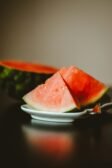 watermelon slice on white ceramic plate